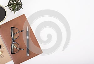 Modern Office desk with notebook, pen, paper book and coffee cup