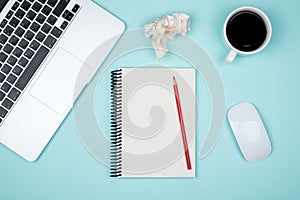 Modern office desk table with laptop and blank notebook page