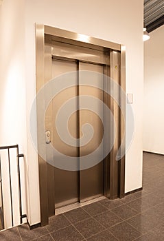 Modern office fragment, shining elevator doors