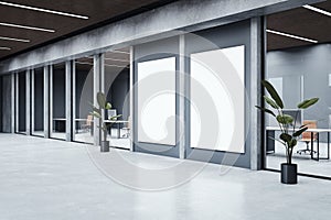 Modern office hallway interior with empty white mock up banners, concrete flooring, glass walls and mock up place.