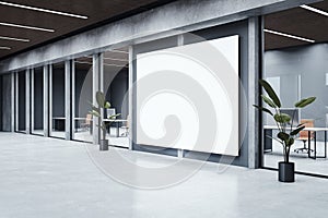 Modern office hallway interior with empty white mock up poster , concrete flooring, glass walls and mock up place.