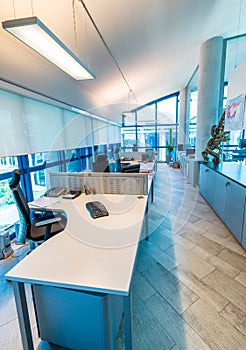 Modern office interior with chairs and desktops