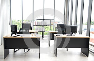 Modern office interior design with table, computer,  monitor, big glass window around the room