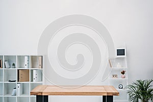 modern office interior with empty wooden table and folders