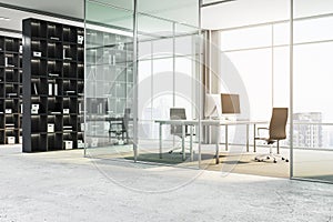 Modern office interior with glass partitions, workspace with city view, and empty bookshelves.
