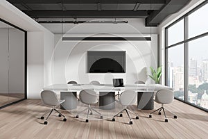 Modern office interior with a long meeting table, chairs, and city view through large windows. Light, contemporary business space