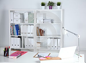 Modern office interior with tables, chairs and bookcases