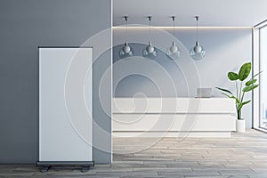 Modern office lobby with blank roll-up mock up banner, white reception desk and concrete walls, window with city view and daylight