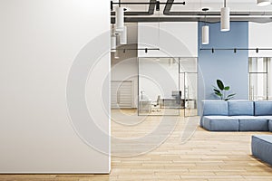 Modern office lobby interior with blank mock up place on wall, blue couch, wooden flooring and panoramic windows with city view.