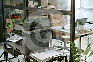 Modern Office Printer Printing Document in Contemporary Workspace Setting