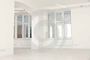 Modern office room with white walls and windows. Interior design