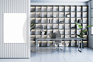 Modern office with shelves or library interior with workplace and mock up banner on wall.