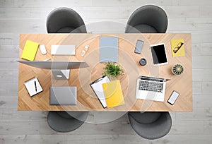 Modern office table with devices and chairs