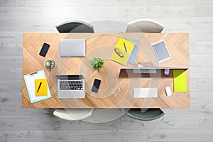 Modern office table with devices and chairs