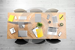 Modern office table with devices and chairs