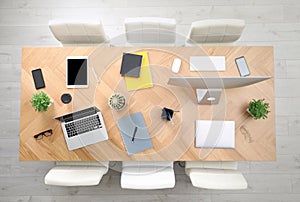 Modern office table with devices and chairs