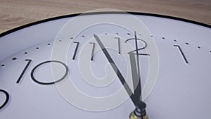 Modern  office wall clock. Close up to a wall clock, with running time pointer. The last five minutes before 12. The Time On The