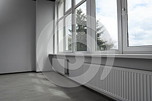 Modern office with window and radiators. Interior design