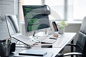 Modern Office Workspace Featuring Computer Monitor Displaying Programming Code