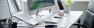 Modern Office Workspace Featuring Computer Monitors Displaying Programming Code
