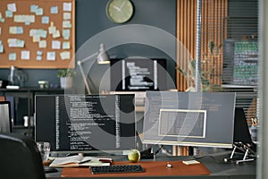 Modern Office Workspace Featuring Computer Monitors Displaying Programming Code