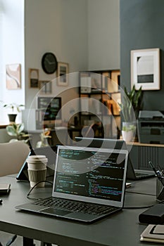 Modern Office Workspace Featuring Laptop Displaying Programming Code