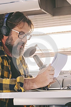 Modern online work in alternative office lifestyle. Traveler use online connection for his job. Man recording and speaking at the