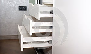 Modern open drawers for storage in a cabinet with mortise handles, modern closet, furniture in the interior slide system.