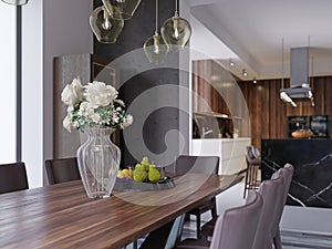 Modern open-plan dining room interior with a large table with formal place settings in a long room with feature windows, a kitchen