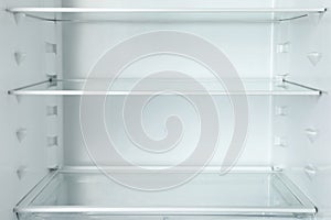 Modern open refrigerator with empty shelves