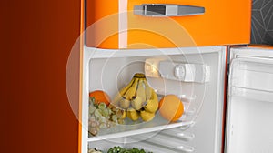 Modern open refrigerator with many different fresh fruits