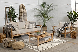 Modern open space with modular sofa and tropical plants