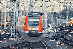 Modern orange commuter train on a railroad