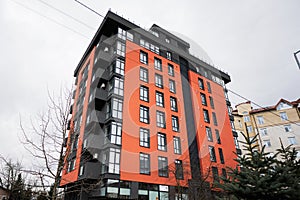 Modern orange residential multistory apartment buildings. Facade of new houses