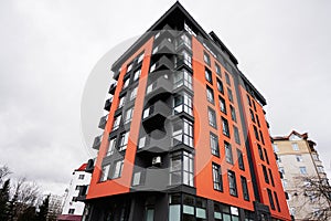 Modern orange residential multistory apartment buildings. Facade of new houses