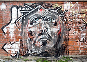 Modern painting graffiti on a wall in Bucharest representing Jesus Christ face