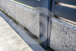 Modern panel fencing in anthracite color, visible connector of the fence foundation.