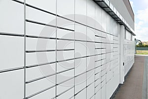 Modern parcel locker with many postal boxes outdoors