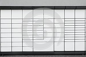 Modern parcel locker with many postal boxes outdoors