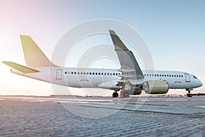 Modern passenger airliner on the airport apron in the sun light