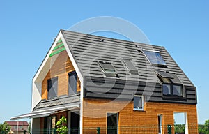 Modern Passive House Exterior. Modern energy efficiency house with skylight windows and solar panels on the roof top