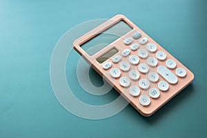 modern peach colour pastel calculator and white button on green background, finance accounting concept