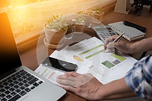 Modern people doing business, graphs and charts being demonstrated on wooden desk in office