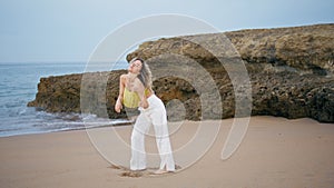Modern performer dancing beach summer day. Flexible woman performing dance