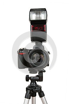 Modern photo camera with flash on tripod