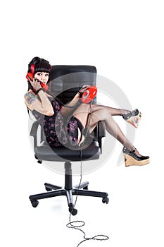 Modern pinup girl in office armchair