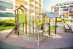 Modern playground on yard in the park near block of flats. Child concept.