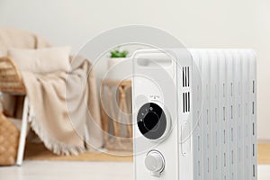 Modern portable electric heater indoors, closeup. Space for text