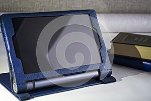 Modern portable equipment. The Lenovo Yoga tablet with a support in a cover of blue color.