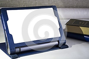 Modern portable equipment. The Lenovo Yoga tablet with a support in a cover of blue color. White and clean screen.